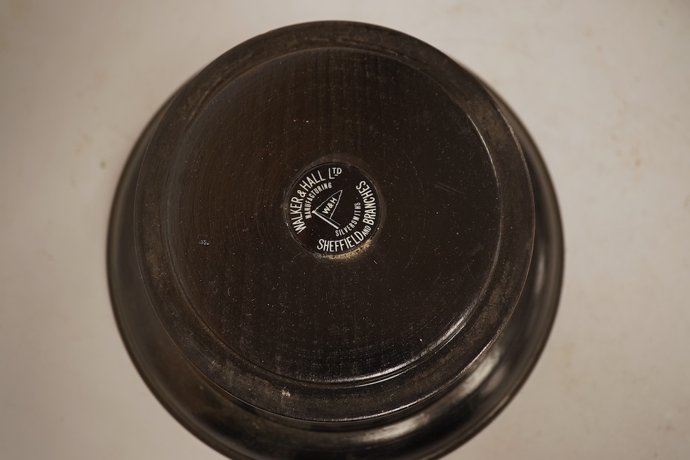 A George VI demi-fluted silver rose bowl, by Walker & Hall, Sheffield, 1939, diameter 14.4cm, 7.2oz, on an ebonised socle.